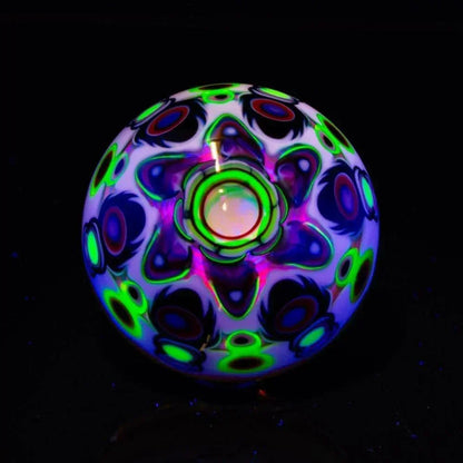 Heady glass marble with UV-reactive opal and neon pattern on black background