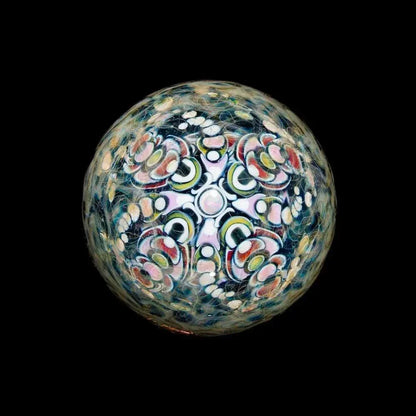 Intricate multicolor glass marble with symmetrical patterns on a black background