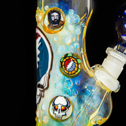 Close-up of a fumed glass bong with colorful marbles featuring skull and face designs