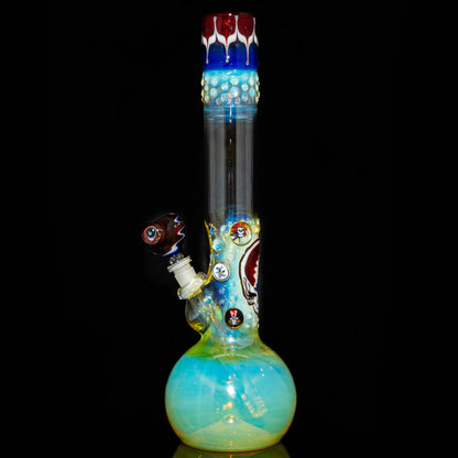 Fumed glass bong with colorful accents and detailed art on black background