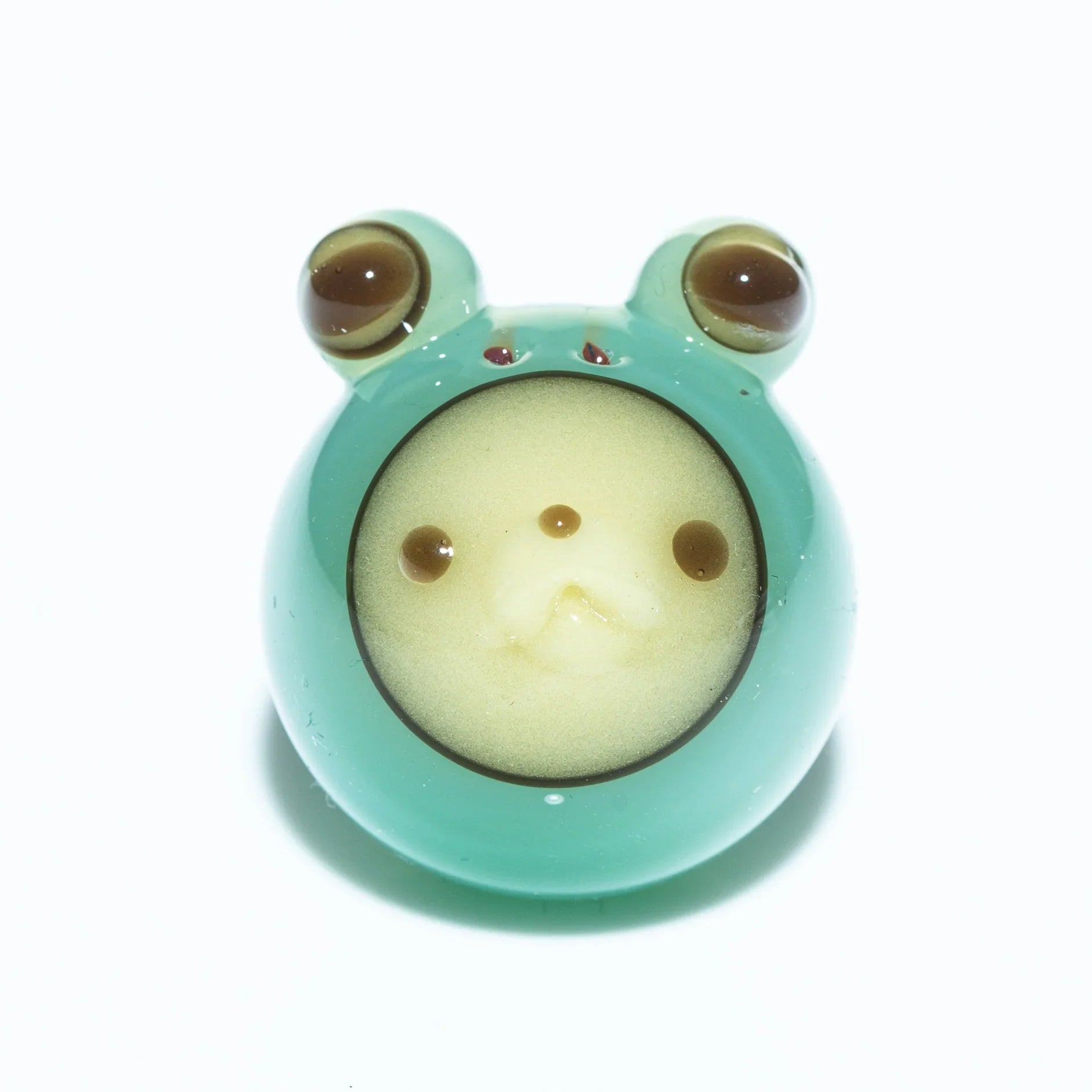 Handcrafted glass frog carb cap with green body and detailed face for smoking accessories