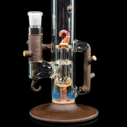 Heady glass water pipe with tree branch accents, intricate percolator, and colorful glass details.