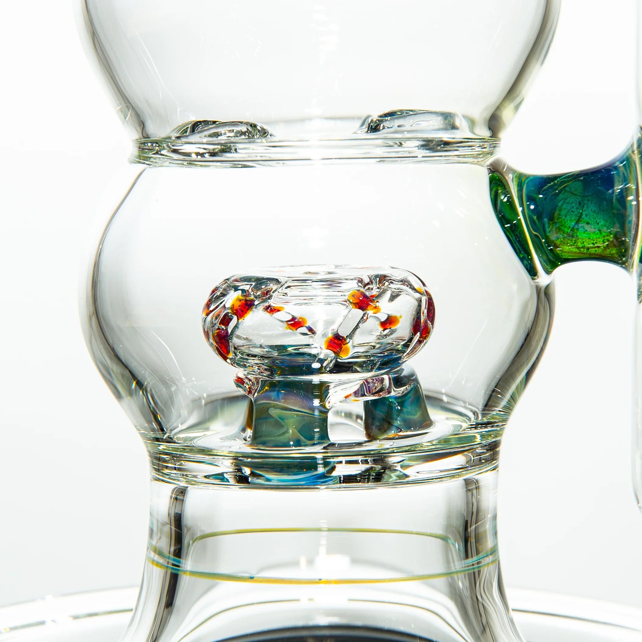 Close-up of intricate clear glass water pipe with colorful glass accents and percolator