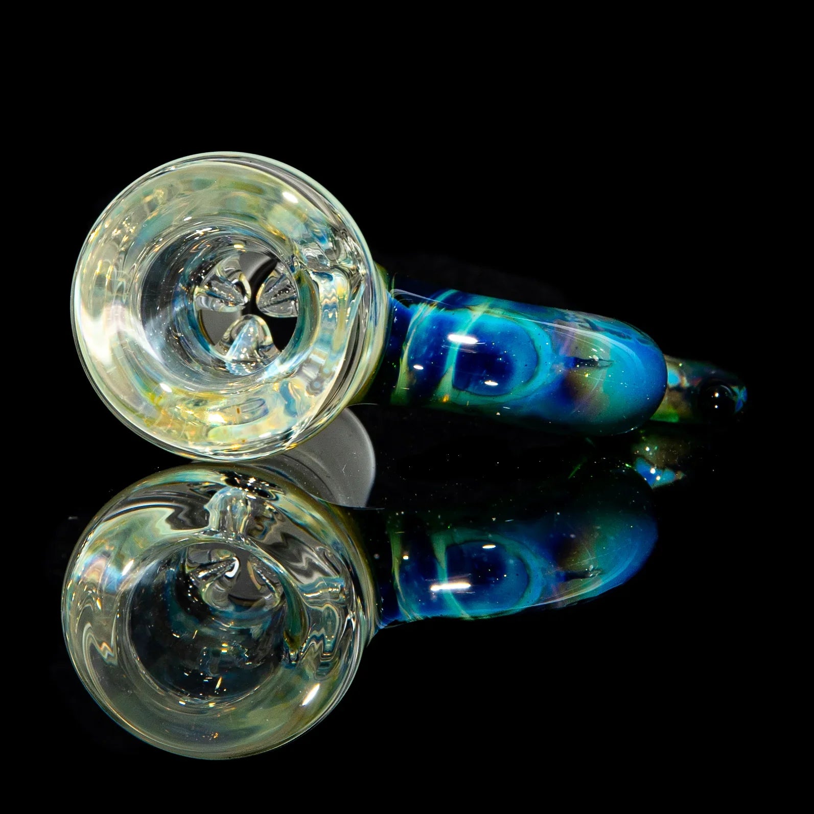 Colorful glass hand pipe with blue and green swirls, displayed on reflective black surface