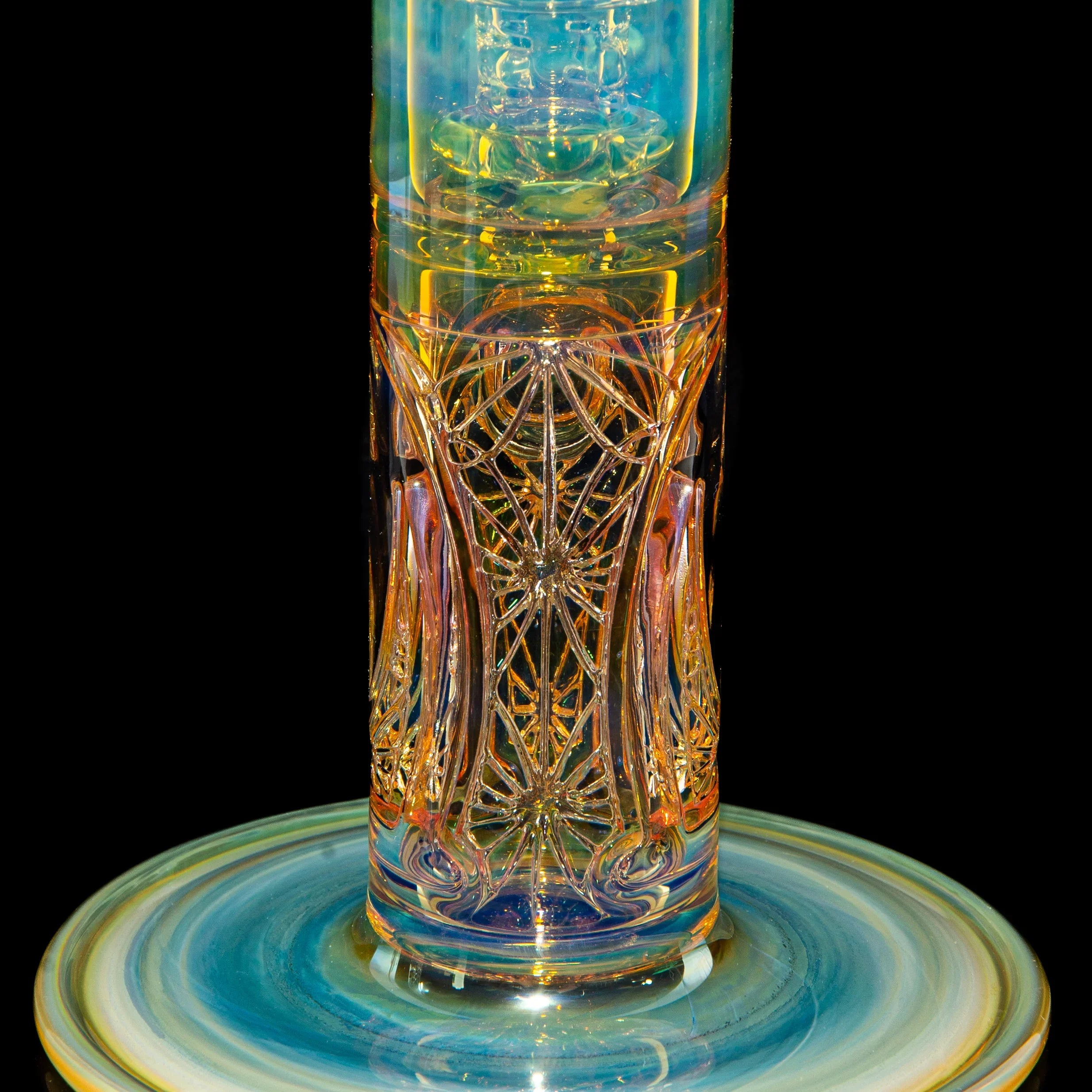 Intricately designed glass water pipe with colorful, detailed patterns and a swirled base.