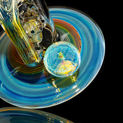 Heady glass water pipe base with swirling blue, yellow, and orange colors and marble accent