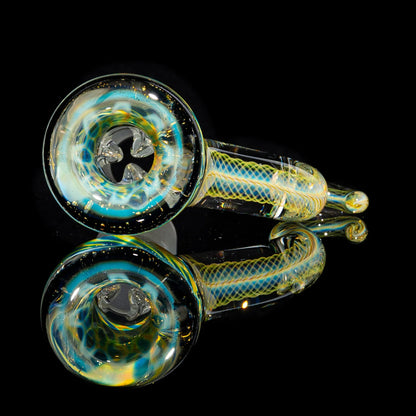 Colorful hand-blown glass pipe with swirl patterns reflected on black surface