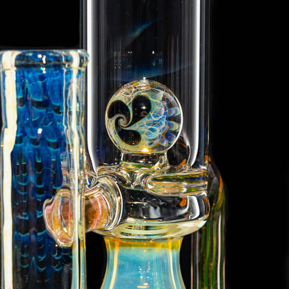Close-up of a heady glass water pipe with a colorful swirl marble accent and blue details