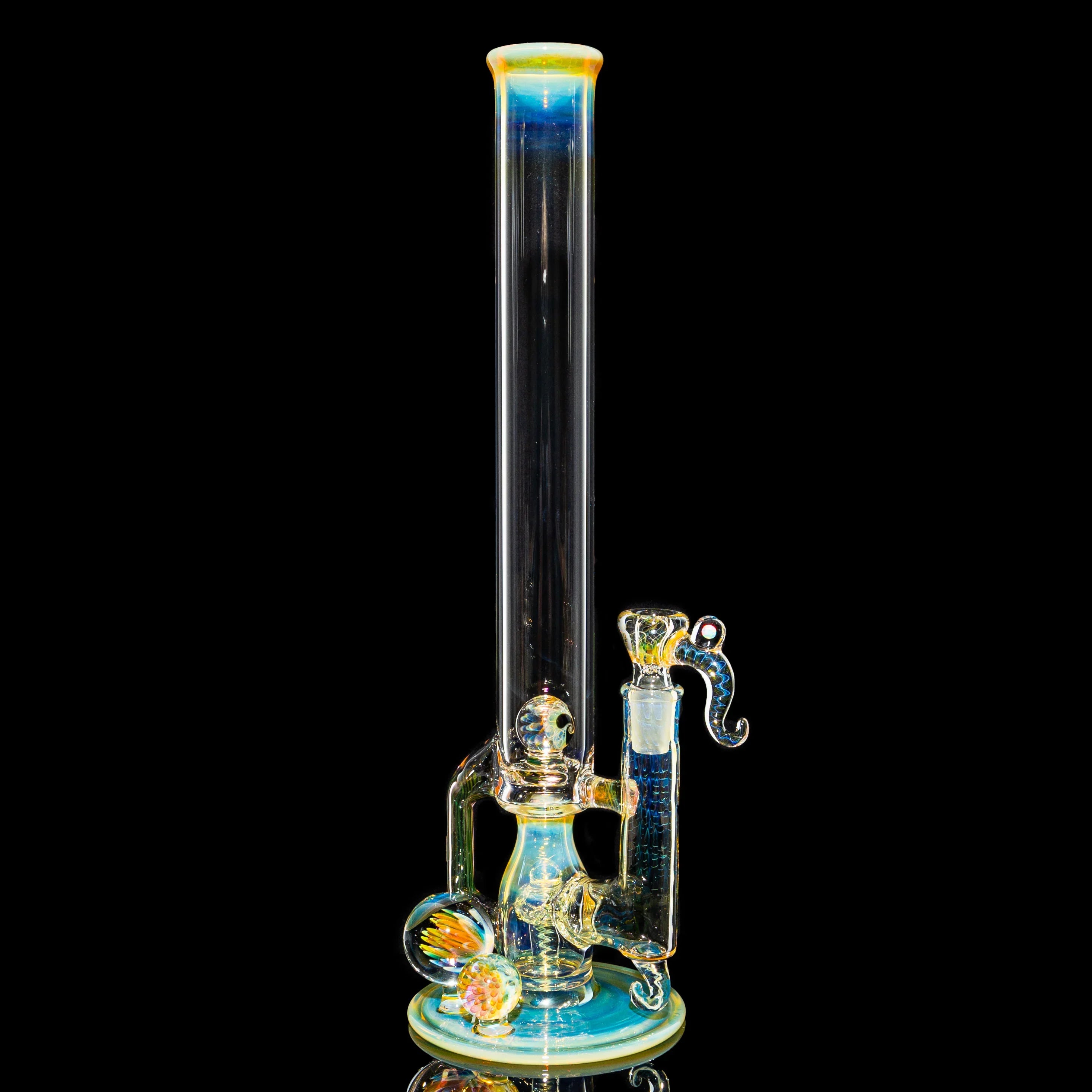 Artistic heady glass water pipe with intricate colorful detailing on a black background