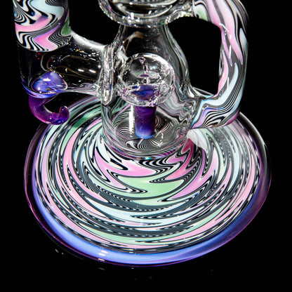 Colorful heady glass water pipe with intricate swirled patterns on black background