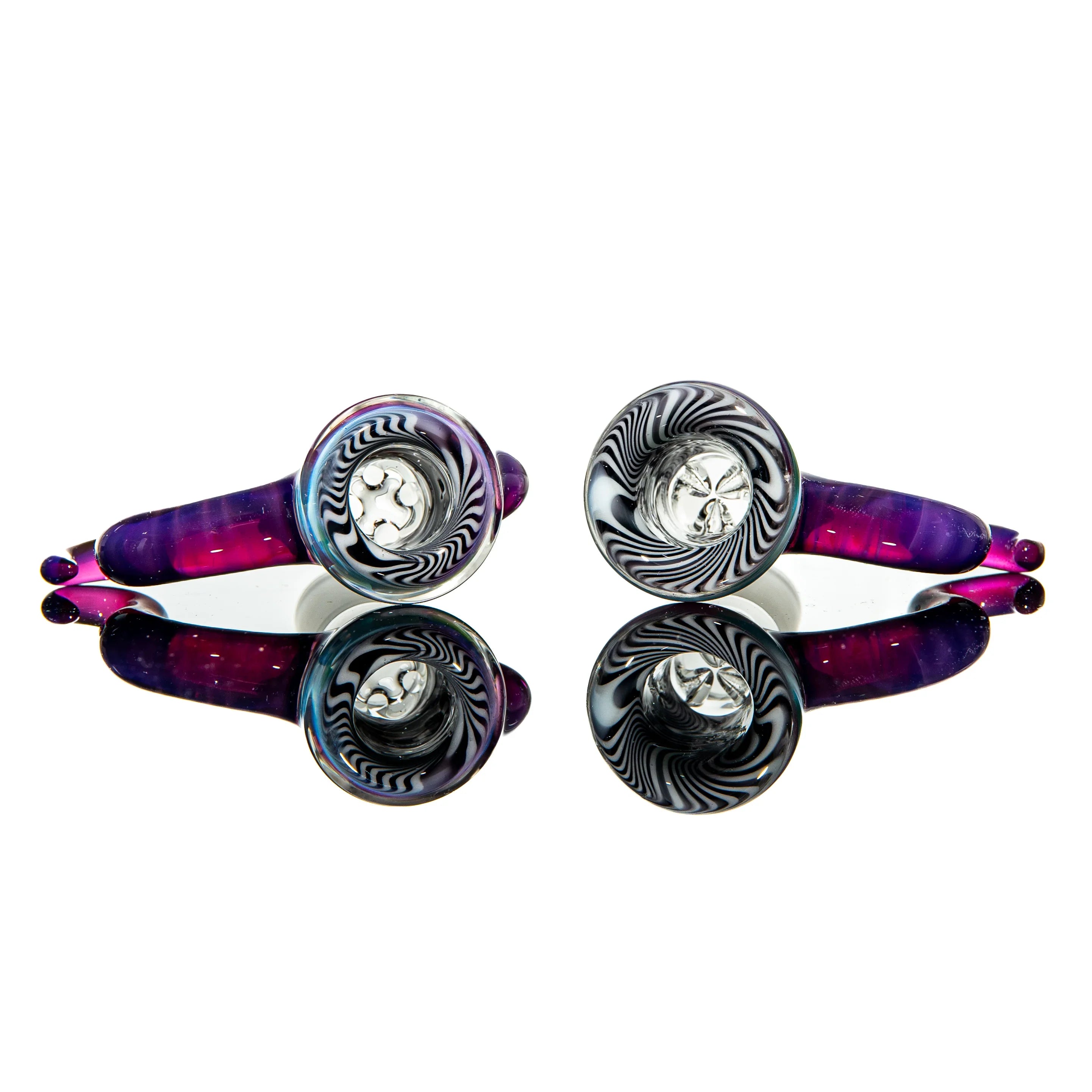 Two colorful glass hand pipes with black and white swirl designs and purple accents, mirrored on white background
