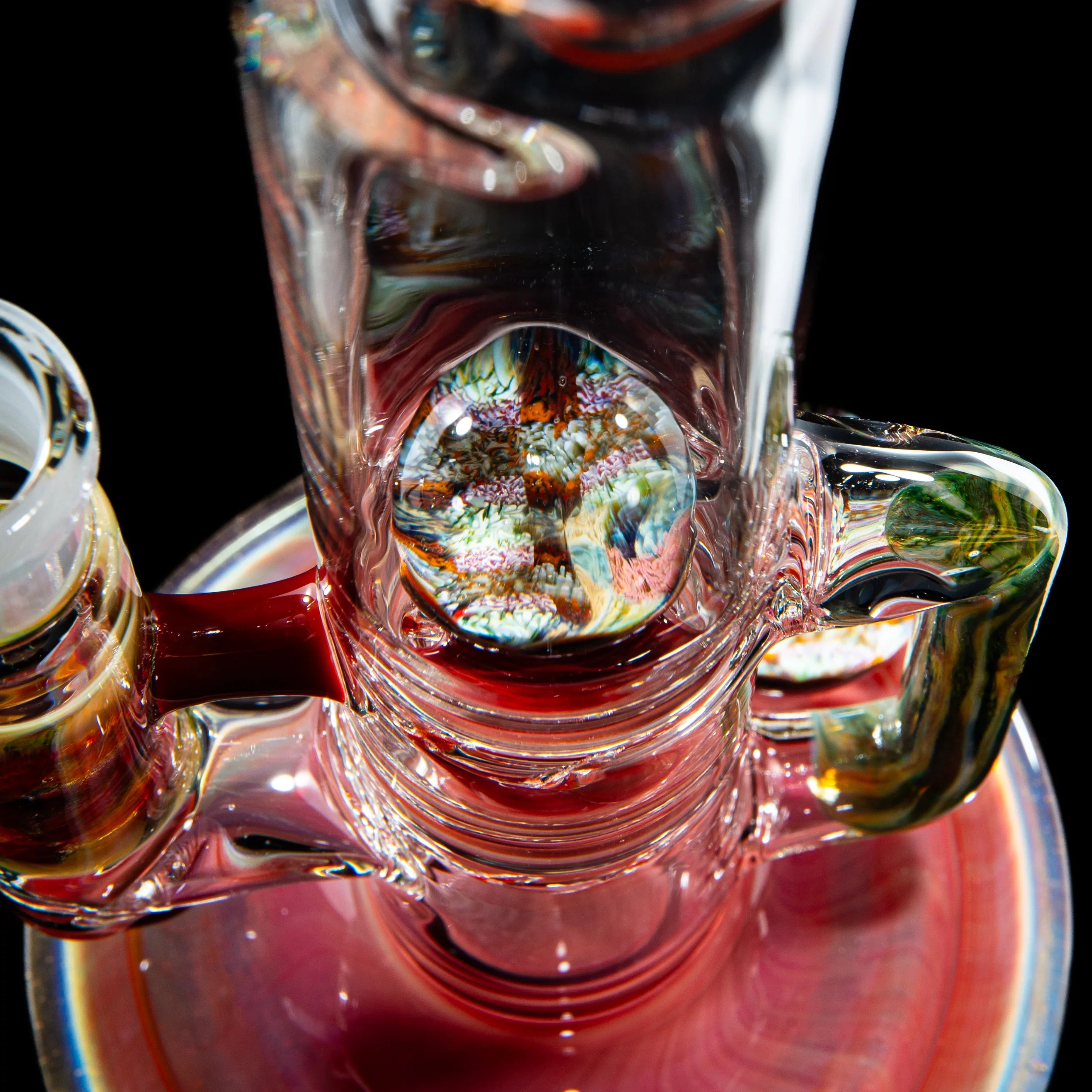 Close-up of intricate heady glass water pipe with colorful marble detail and vibrant accents