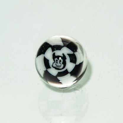 Black and white glass marble featuring a cartoon face design on a white background.