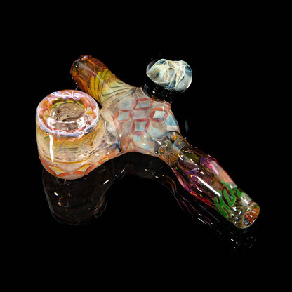 Heady glass hand pipe with intricate patterns and colorful accents on a black background