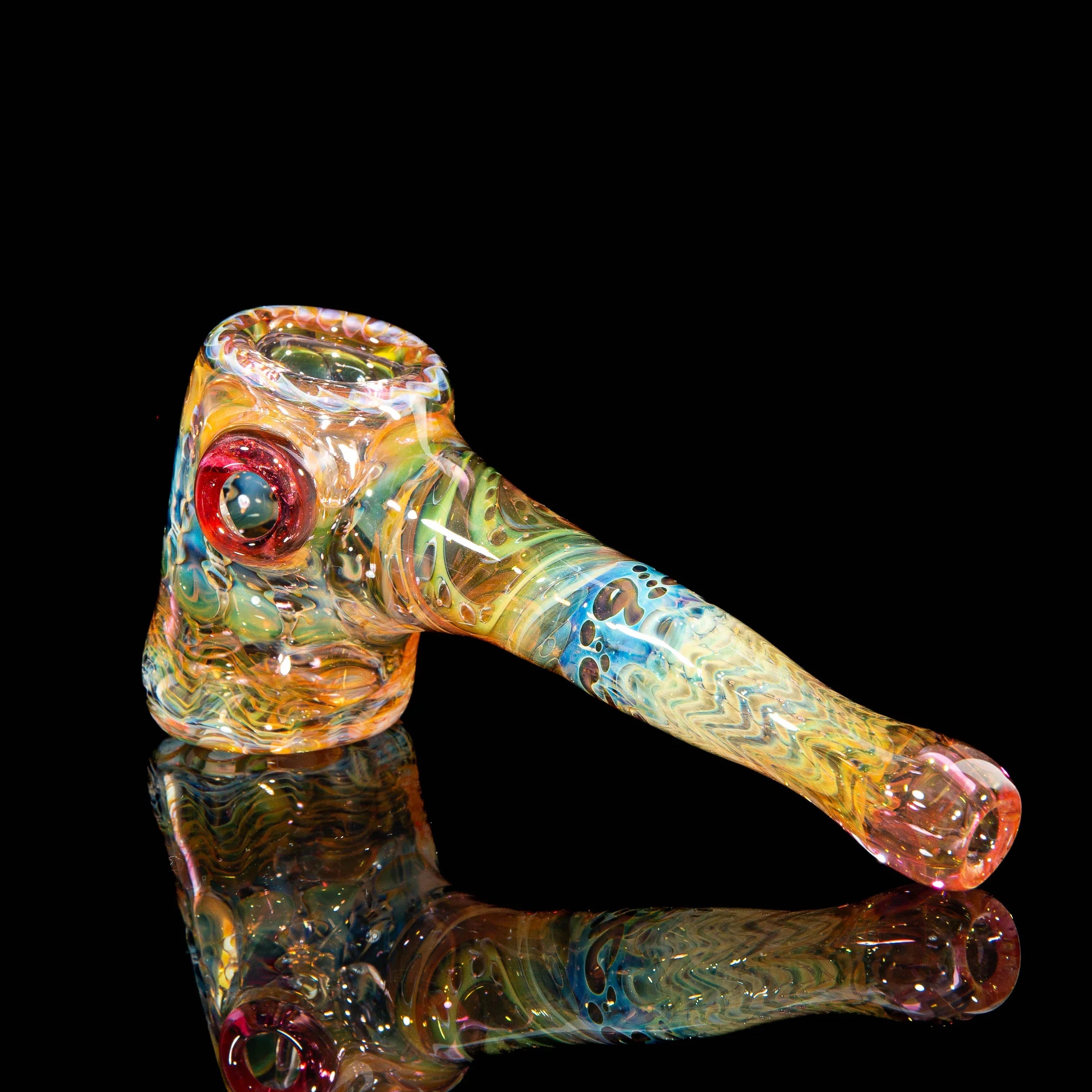 Colorful heady glass smoking pipe with unique patterns and vibrant swirl details on black background