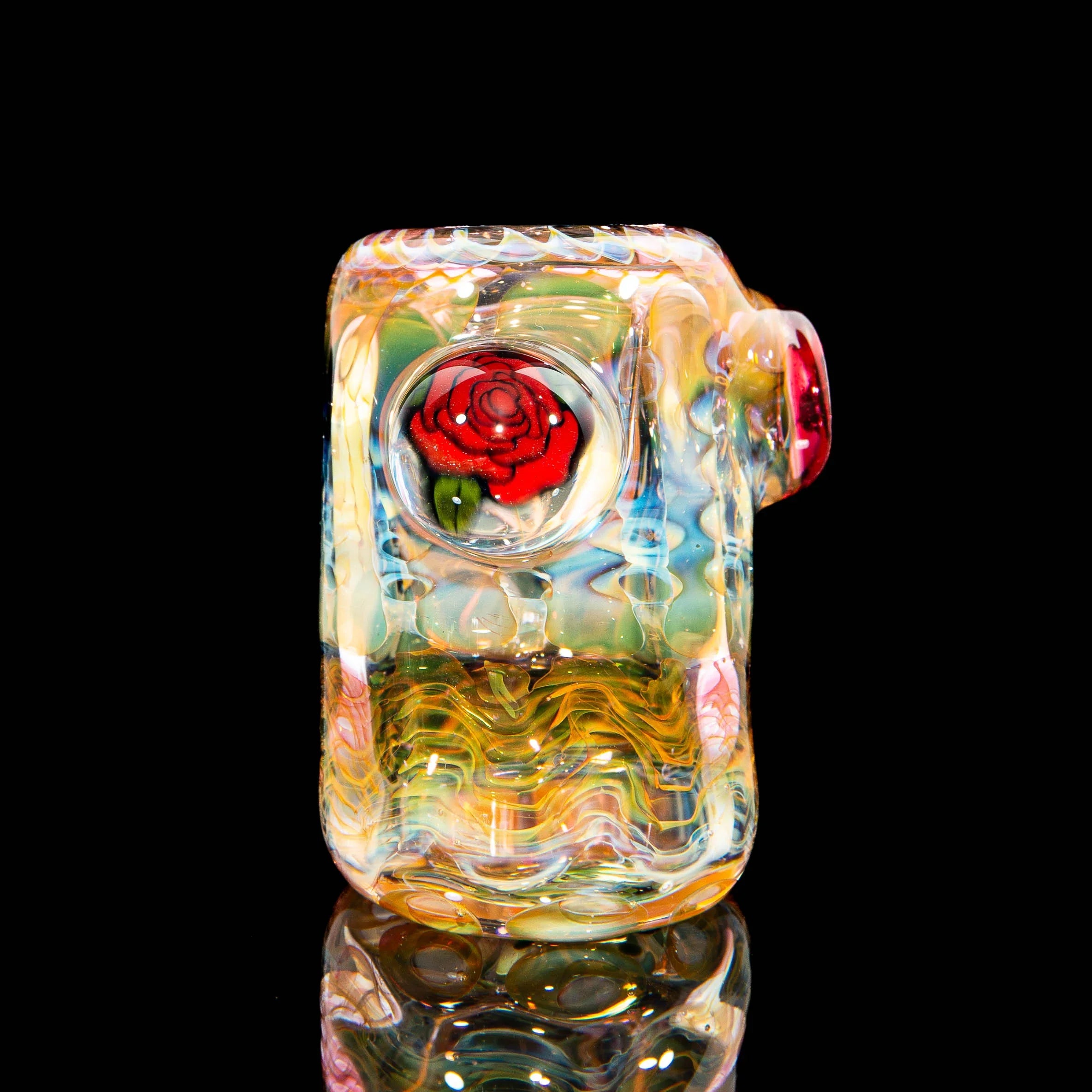 Heady glass pipe with vibrant colors and red rose marble detail on black background