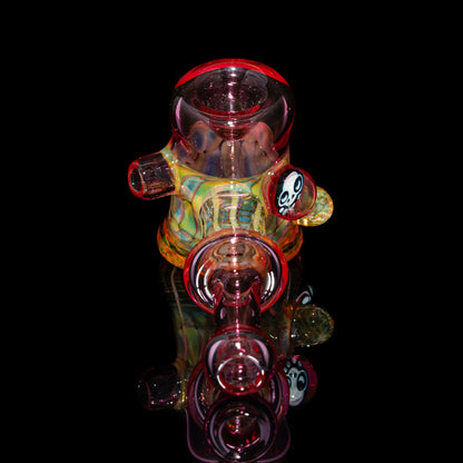 Colorful heady glass dab rig with bear shape and skull accent on black background