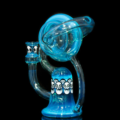 Blue glass recycler water pipe with white bear skull designs on black background