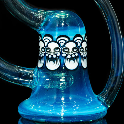 Close-up of blue glass water pipe with white skull art accents and curved clear neck