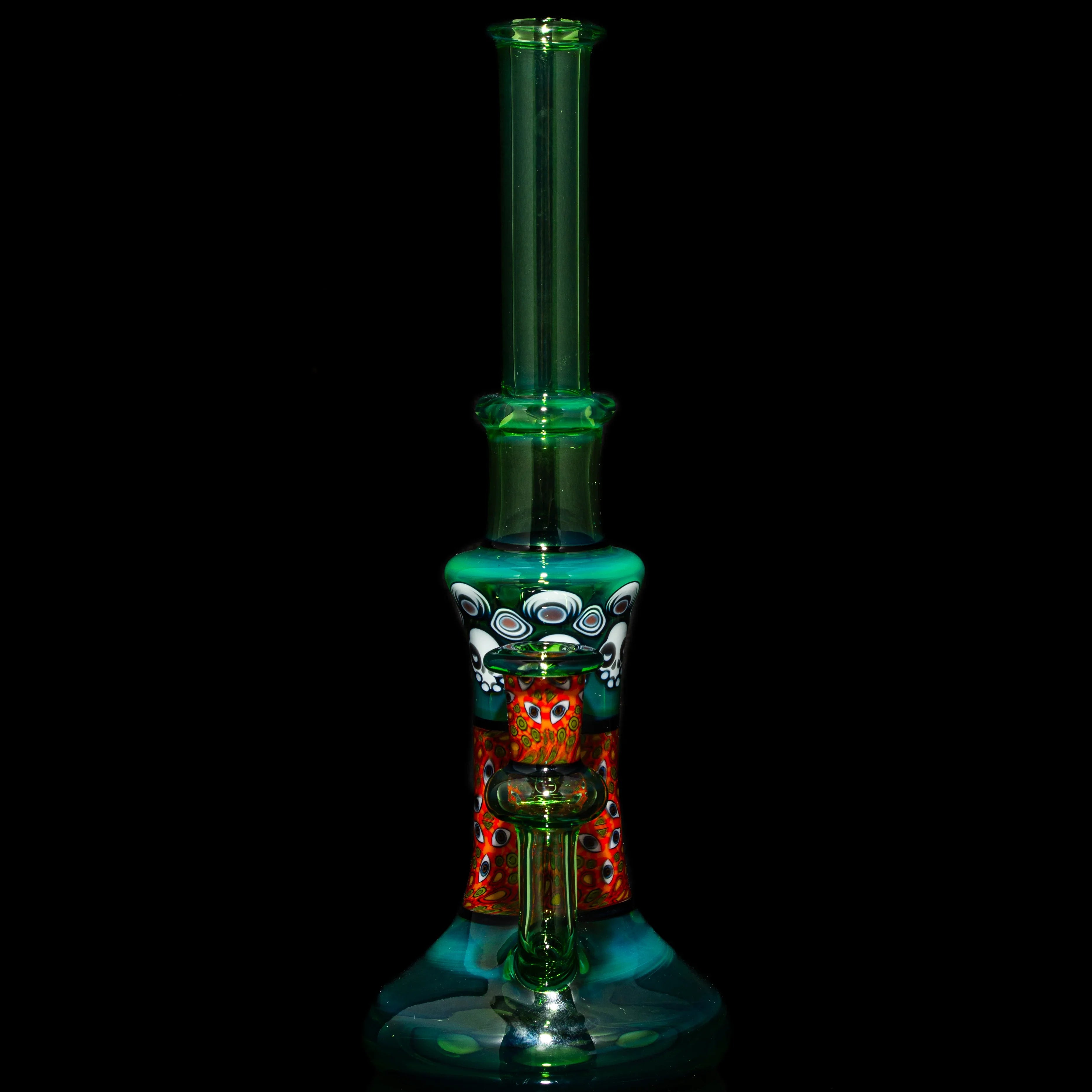 Colorful hand-blown glass water pipe with intricate patterns on a black background