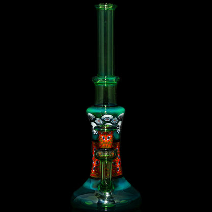 Colorful hand-blown glass water pipe with intricate patterns on a black background