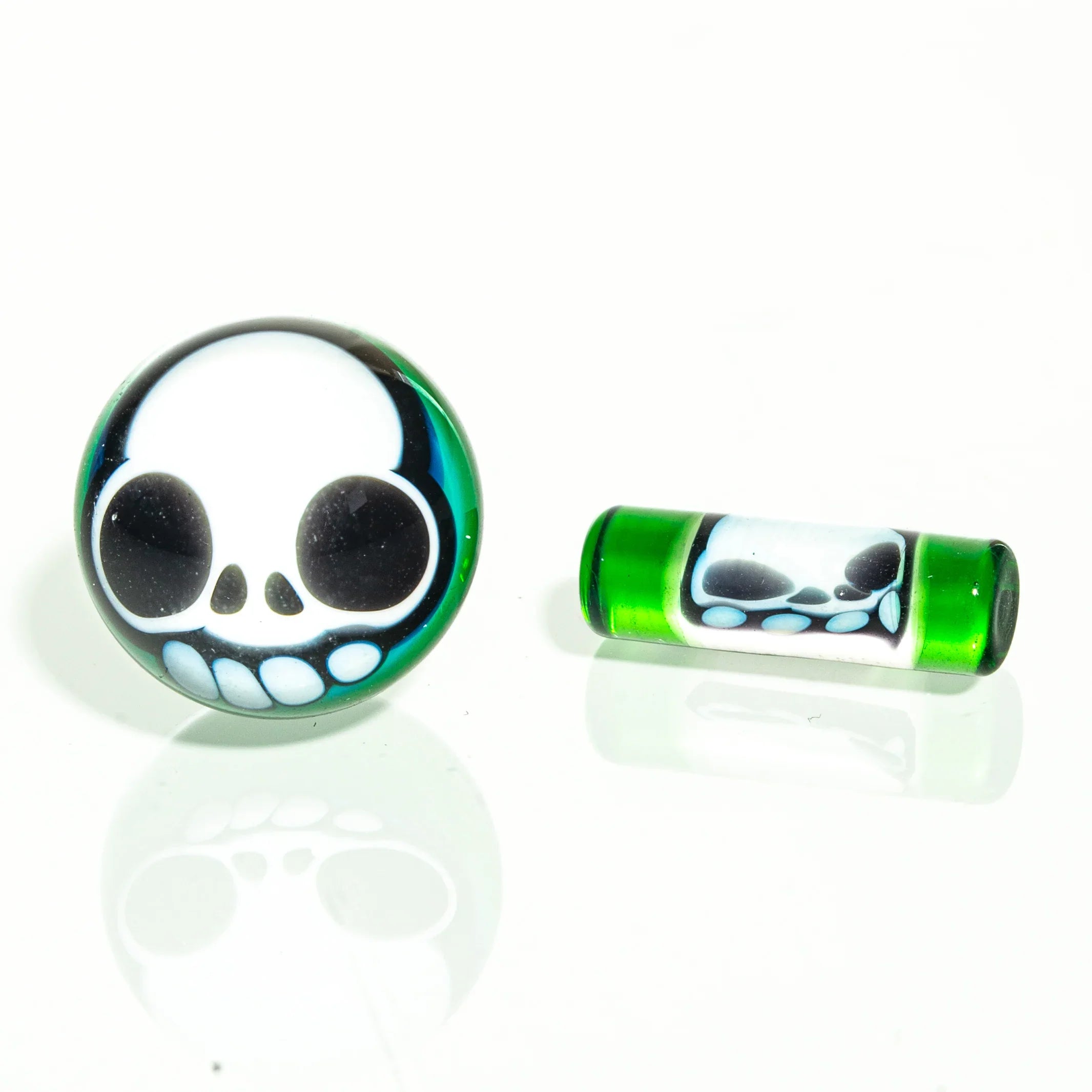 Green glass terp pearls and pill with skull design on white background