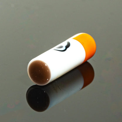 Glass cigarette one hitter bat with orange tip on black reflective surface