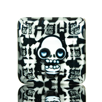 Square glass tray with cartoon skull and bear faces in black and white pattern