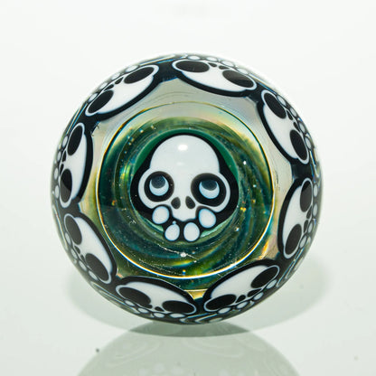 Glass marble with skull design and black and white accents, smoking accessory