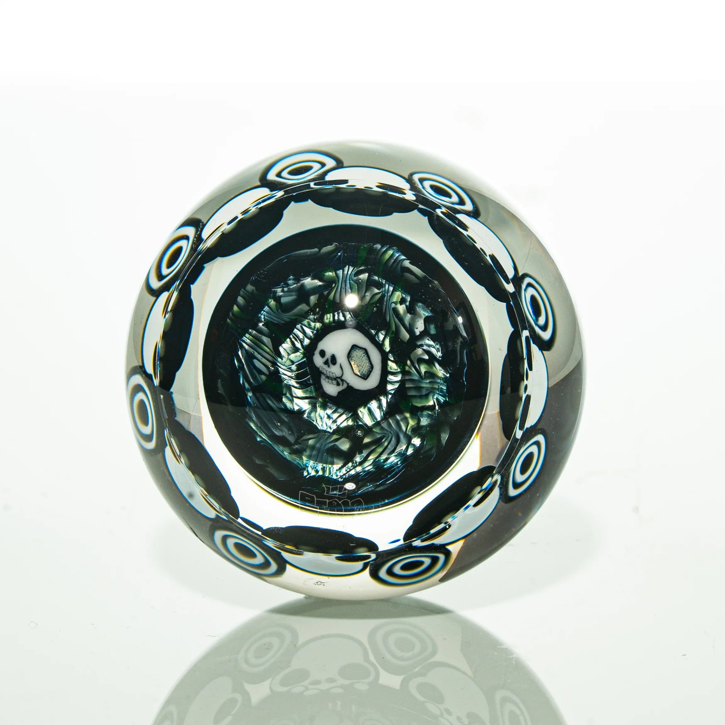 Handcrafted glass marble with skull design and intricate colored patterns