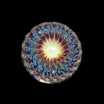 UV reactive glass art flower marble with intricate swirl patterns, black background
