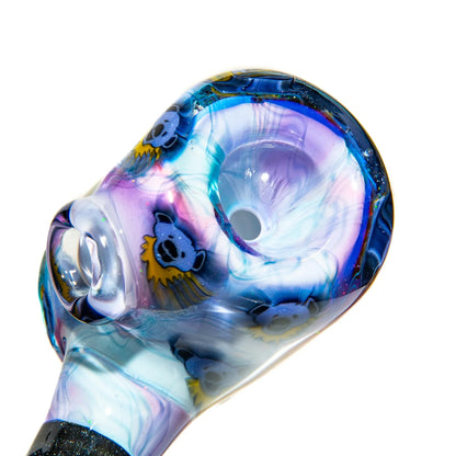 Colorful glass hand pipe with swirling patterns and blue bear designs