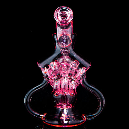 Intricate pink glass water pipe with artistic design on black background