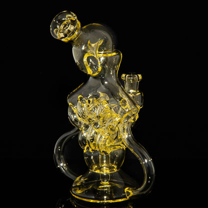 Intricate clear and yellow glass water pipe with abstract artistic design on black background