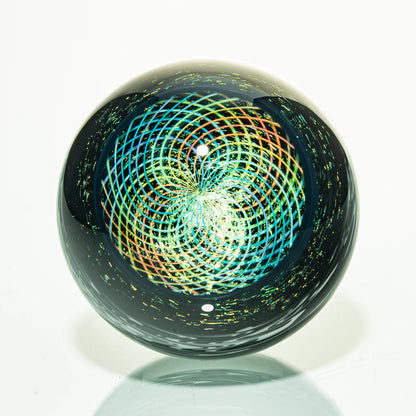 Handcrafted glass marble with intricate rainbow spiral pattern and reflective surface