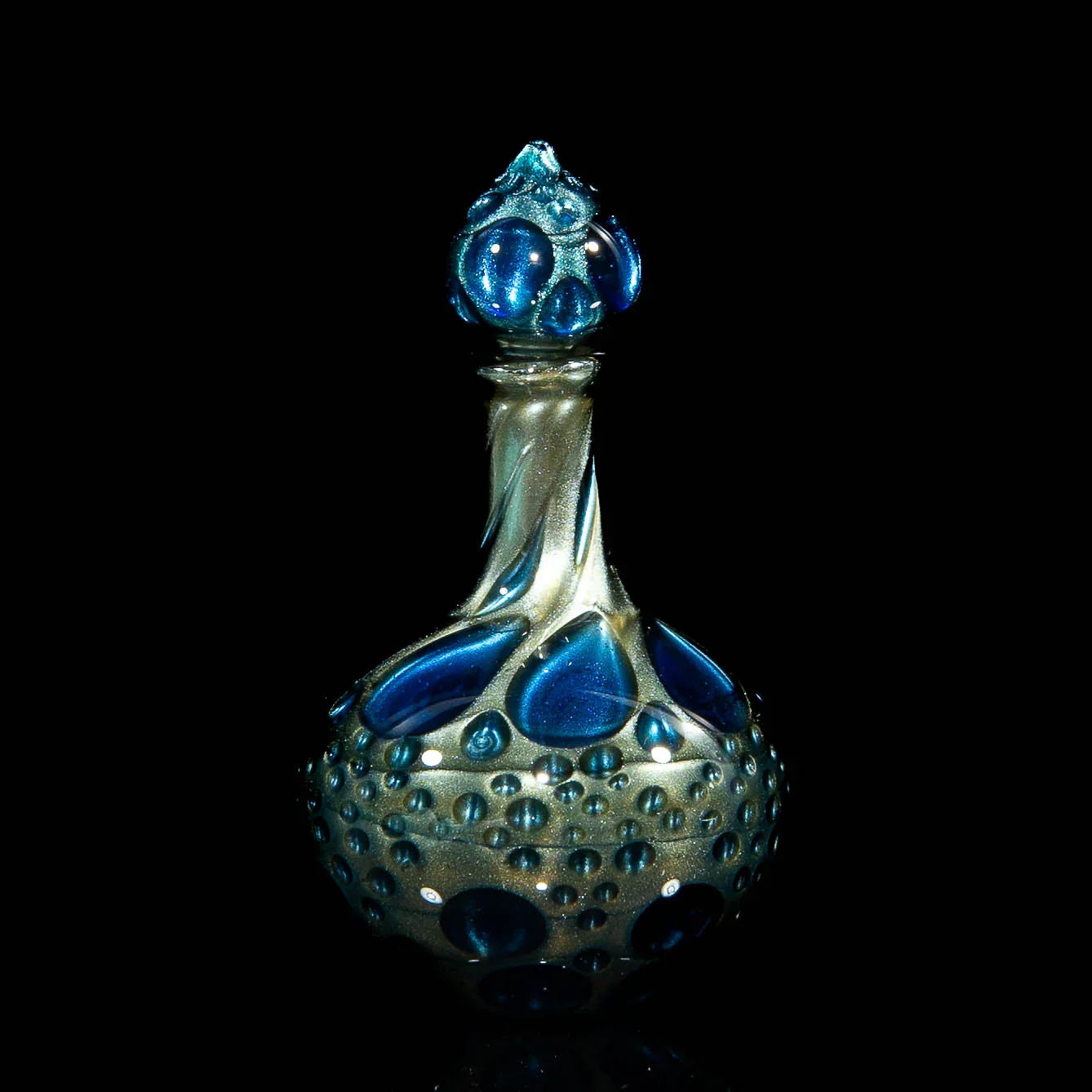 Heady glass art bottle with blue accents and bubble texture on black background