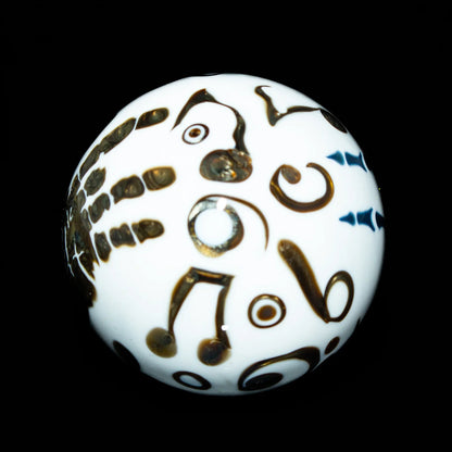 White glass marble with black abstract and musical note designs on black background