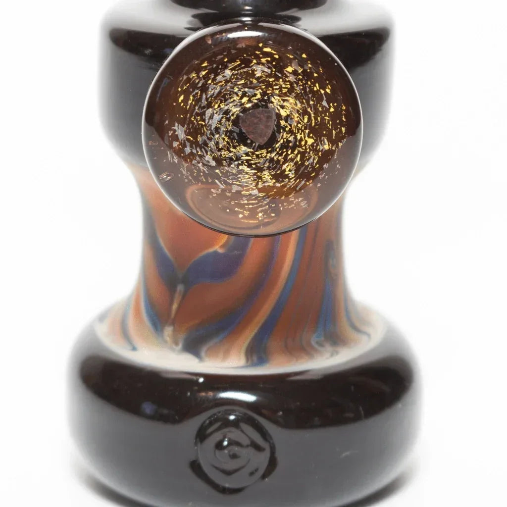 Handblown glass pipe with amber swirls and gold flecks, featuring a dark base and artistic design.