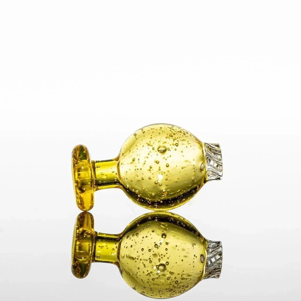 Amber glass pipe with bubble texture and silver accents, reflective surface