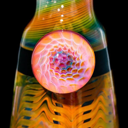 Close-up of a colorful glass water pipe with intricate psychedelic patterns and a round accent