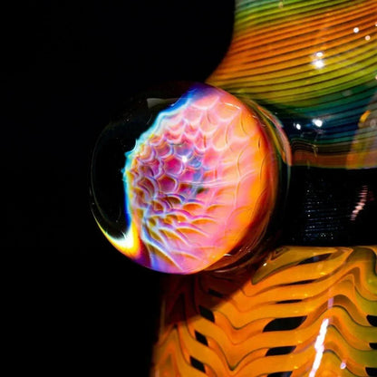 Close-up of colorful glass art detail with intricate patterns on smoking pipe