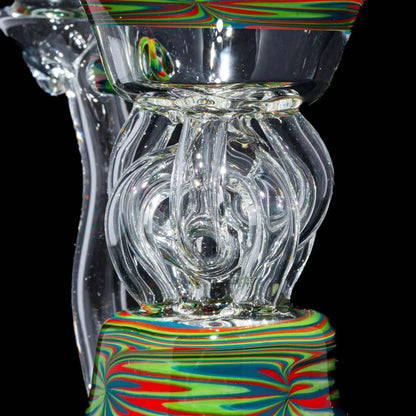 Intricate heady glass rig with colorful red, green, and blue swirl patterns, close-up view