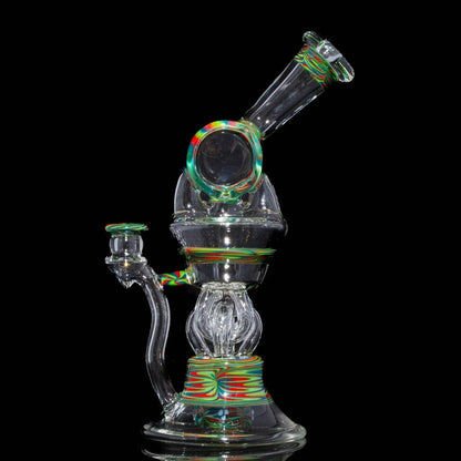 Heady glass water pipe with vibrant red, green, and yellow swirl accents on black background