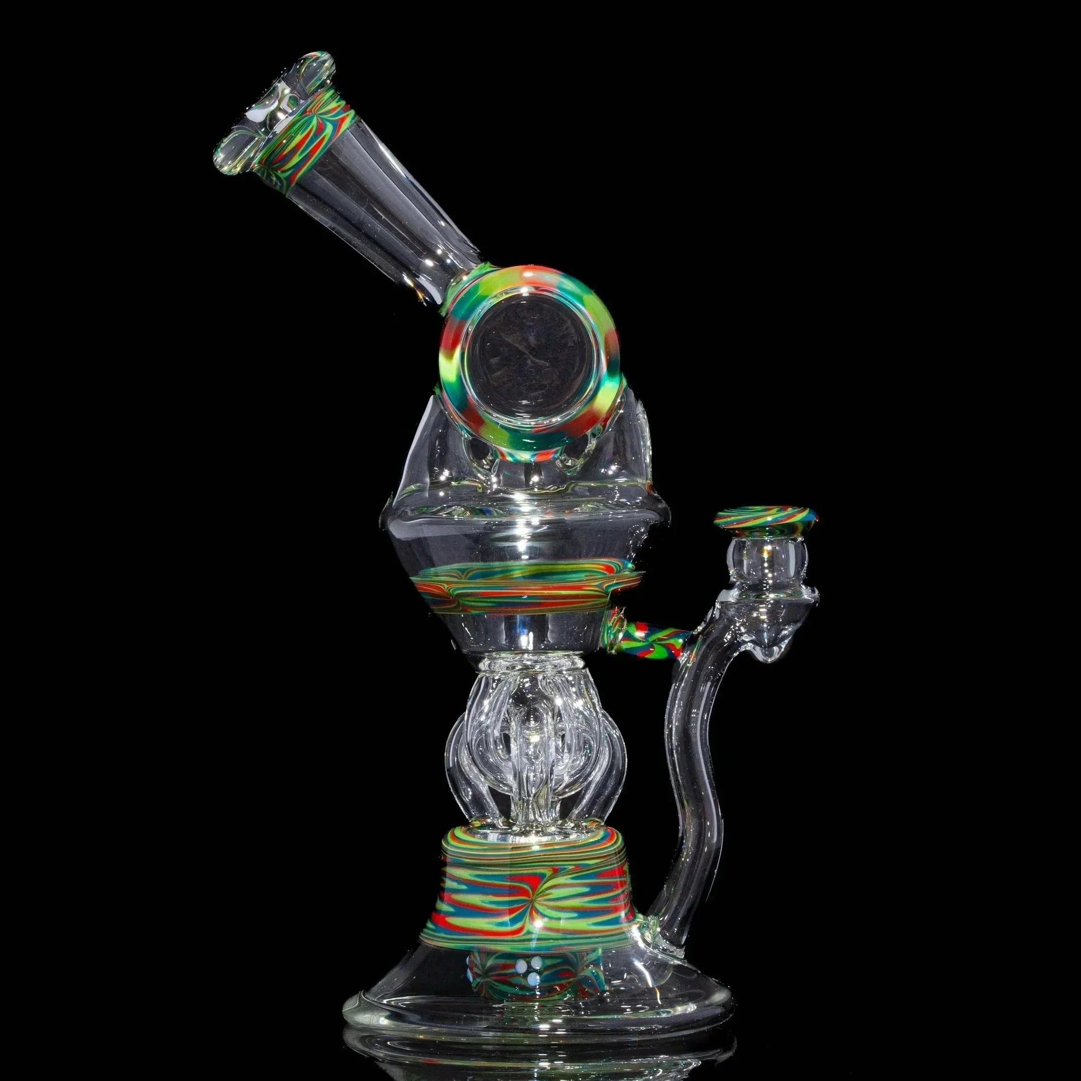 Clear glass water pipe with colorful swirled accents on base and mouthpiece, black background
