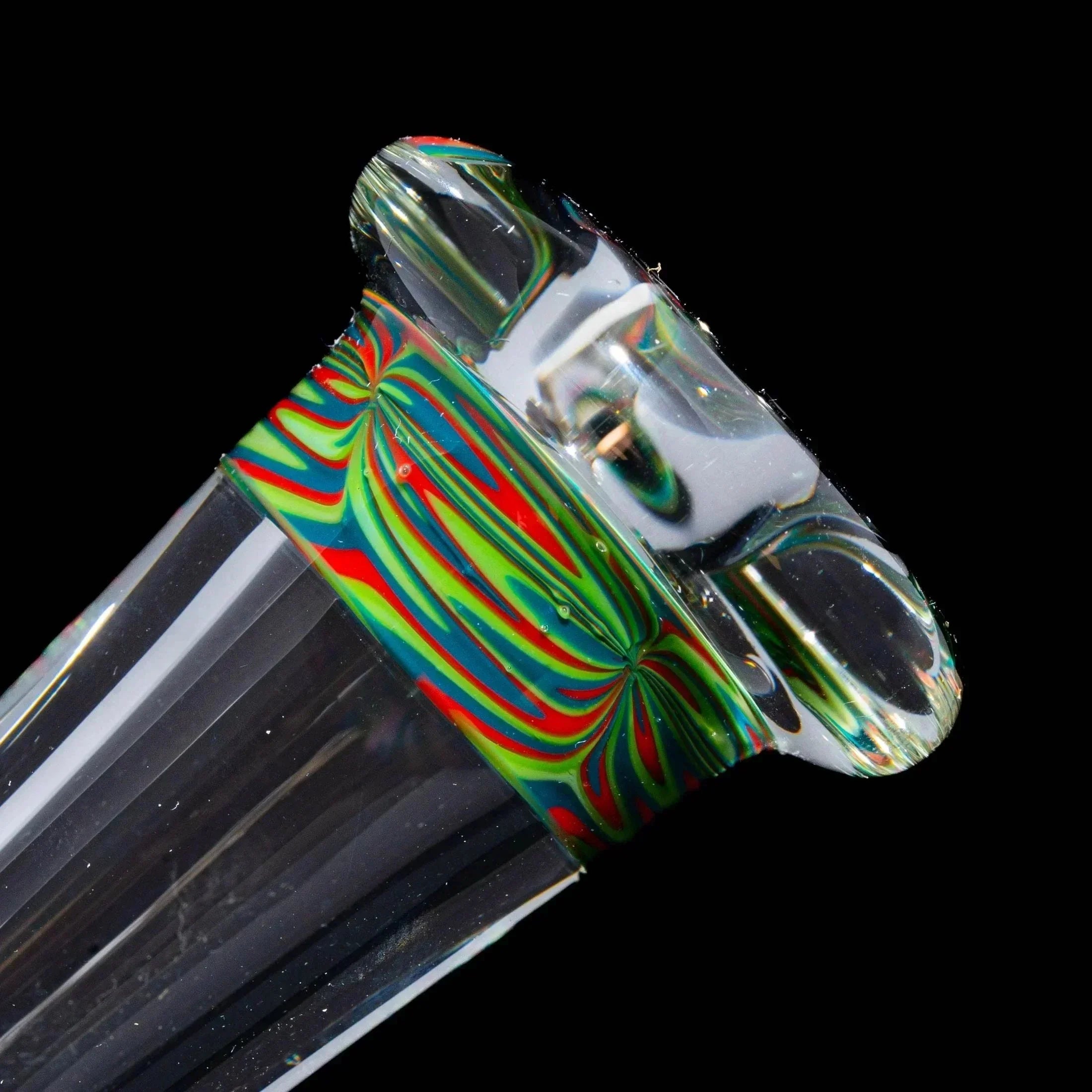 Close-up of clear glass pipe mouthpiece with colorful swirl accents and flared lip