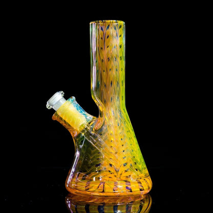 Vibrant yellow and green heady glass bong with intricate swirls and reflective surface