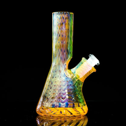 Vibrant rainbow glass bong with wavy patterns and clear downstem, showcasing heady glass artistry.