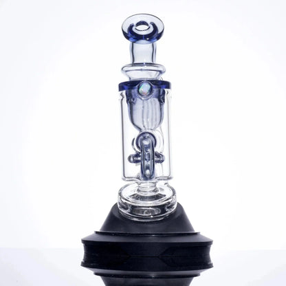Clear glass pipe with blue accents and iridescent bead, displayed on black stand