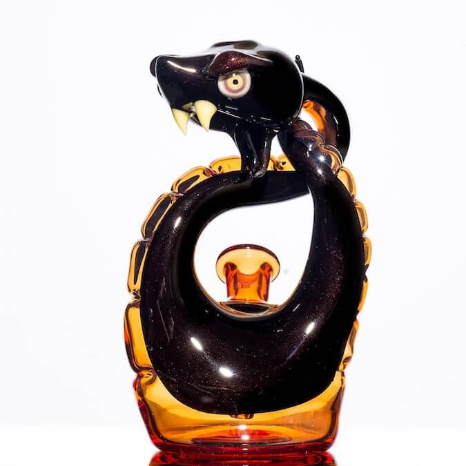 front shot of glass snake made by Niko Cray in Pomegranate over steel wool and tangjello