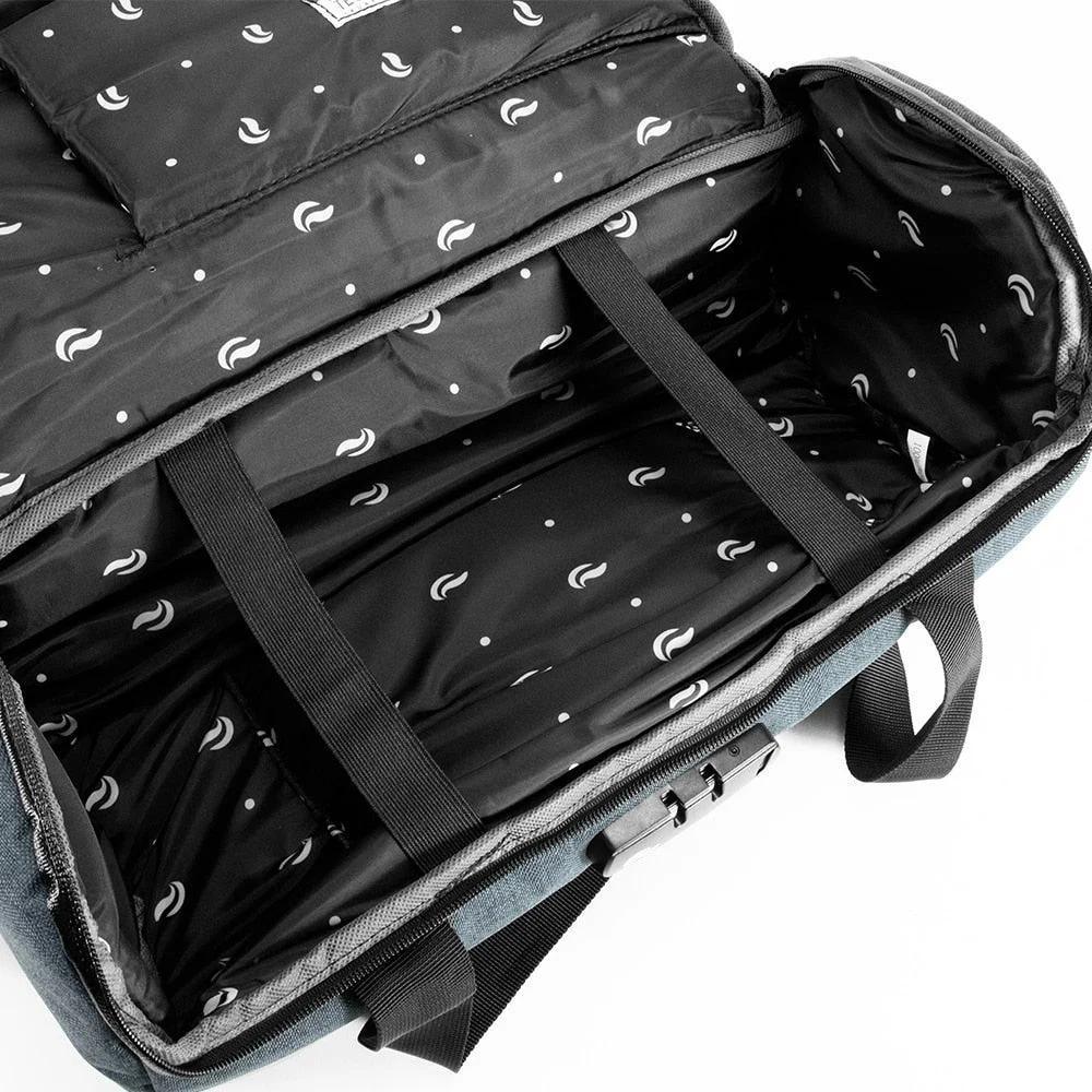 Open navy duffle bag with patterned, padded black interior and adjustable straps